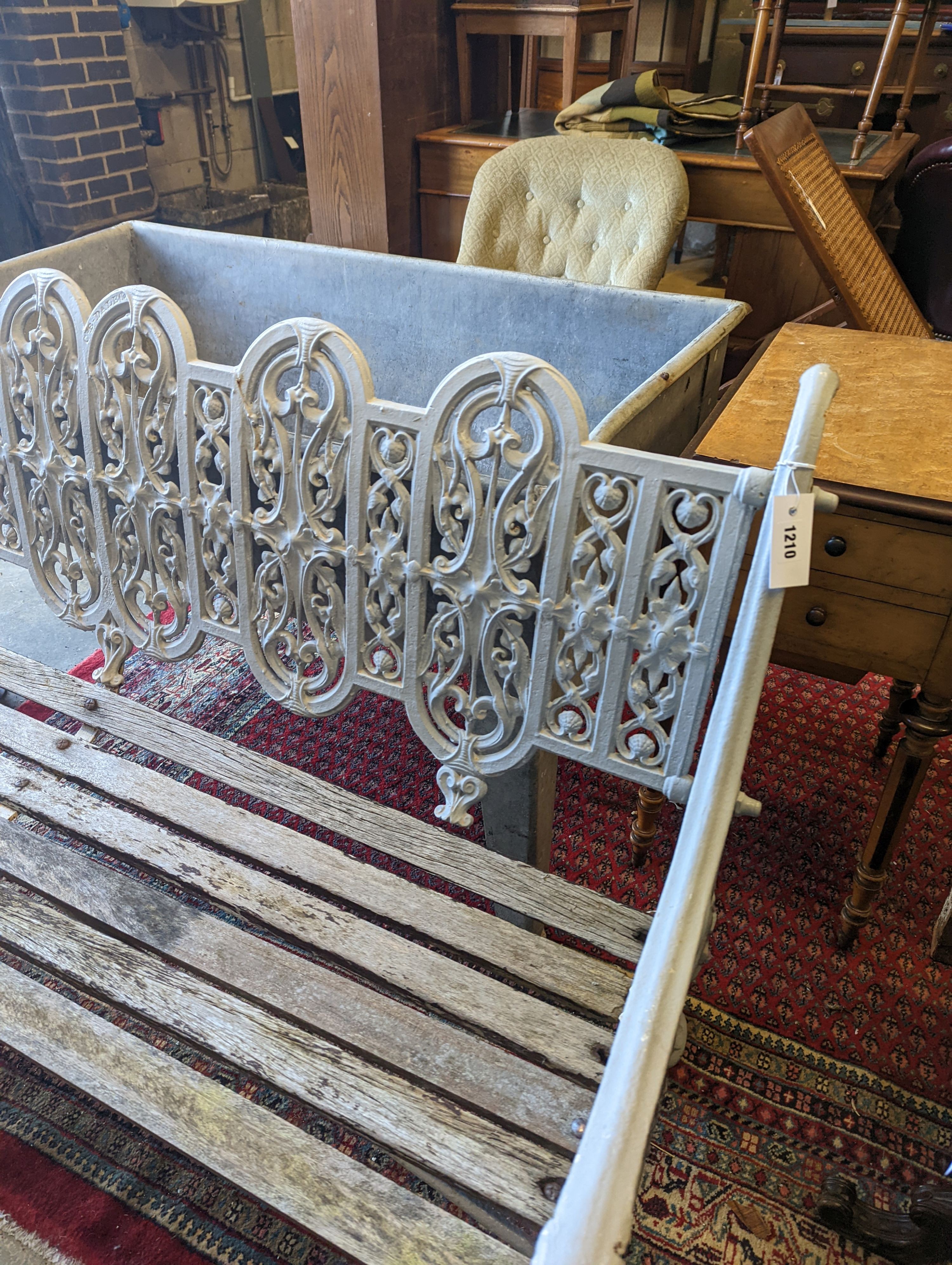 A Victorian Coalbrookdale cast-iron garden bench, length 156cm, depth 68cm, height 94cm (re-painted and seat in need of repair)